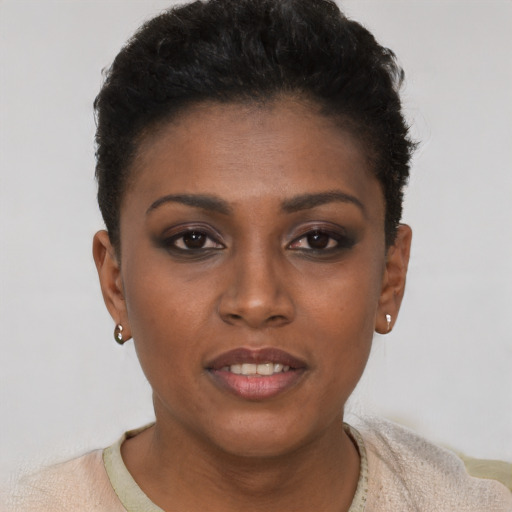 Joyful black young-adult female with short  black hair and brown eyes