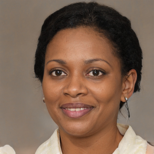Joyful black young-adult female with medium  black hair and brown eyes