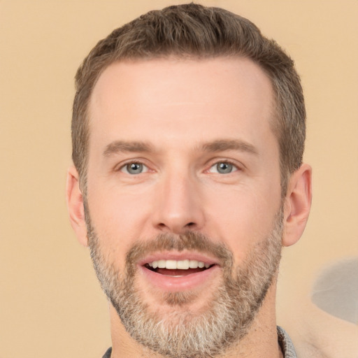 Joyful white adult male with short  brown hair and brown eyes