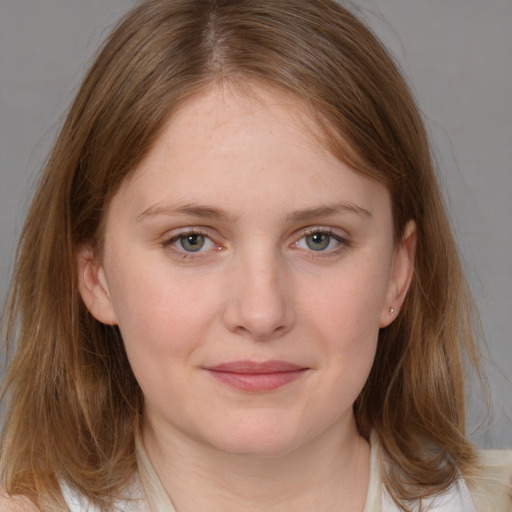 Joyful white young-adult female with medium  brown hair and grey eyes