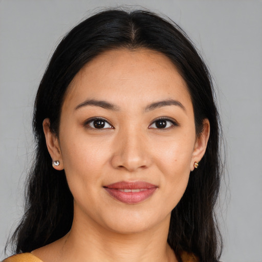 Joyful latino young-adult female with long  brown hair and brown eyes