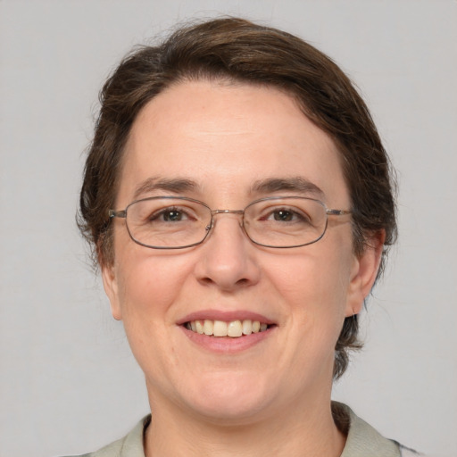 Joyful white adult female with medium  brown hair and grey eyes