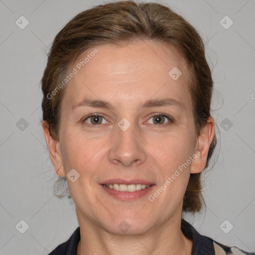 Joyful white adult female with medium  brown hair and grey eyes