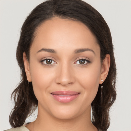 Joyful white young-adult female with long  brown hair and brown eyes