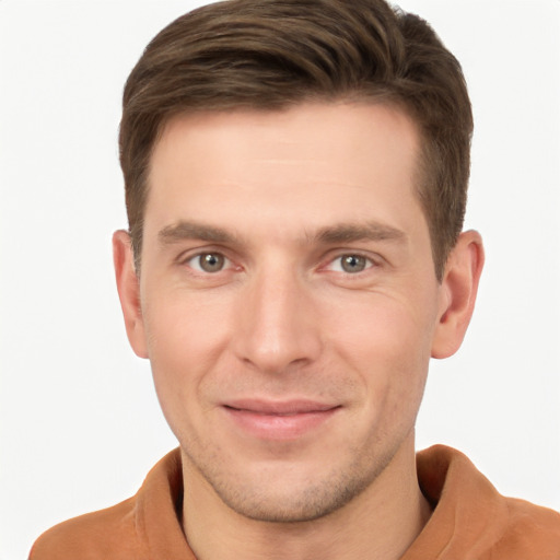 Joyful white young-adult male with short  brown hair and grey eyes