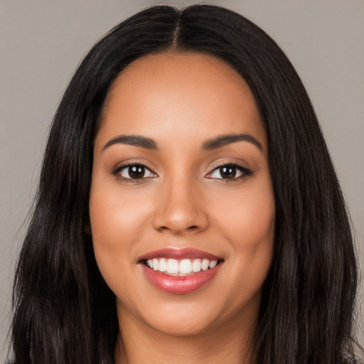 Joyful latino young-adult female with long  black hair and brown eyes