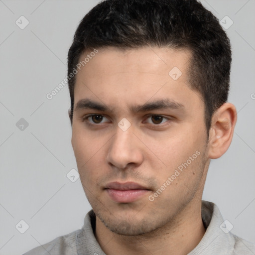 Neutral white young-adult male with short  black hair and brown eyes