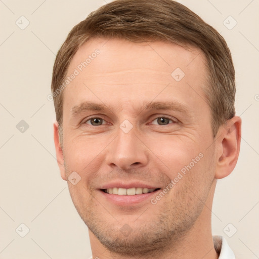 Joyful white adult male with short  brown hair and brown eyes