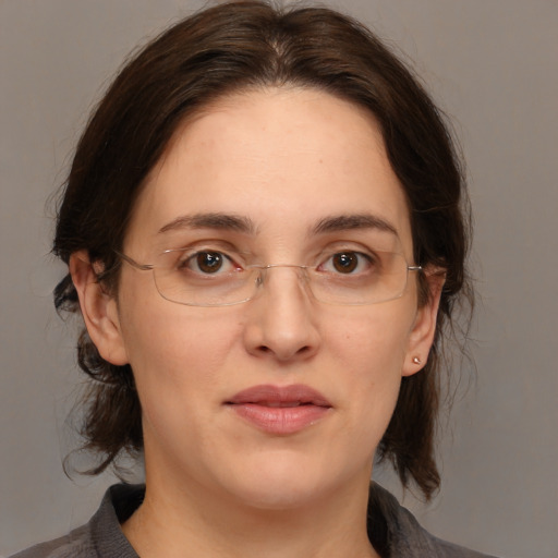 Joyful white adult female with medium  brown hair and brown eyes