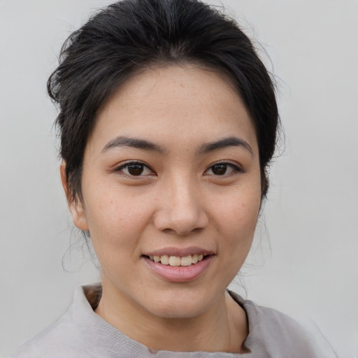 Joyful asian young-adult female with short  brown hair and brown eyes