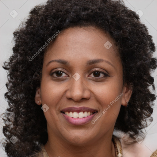 Joyful black young-adult female with medium  brown hair and brown eyes