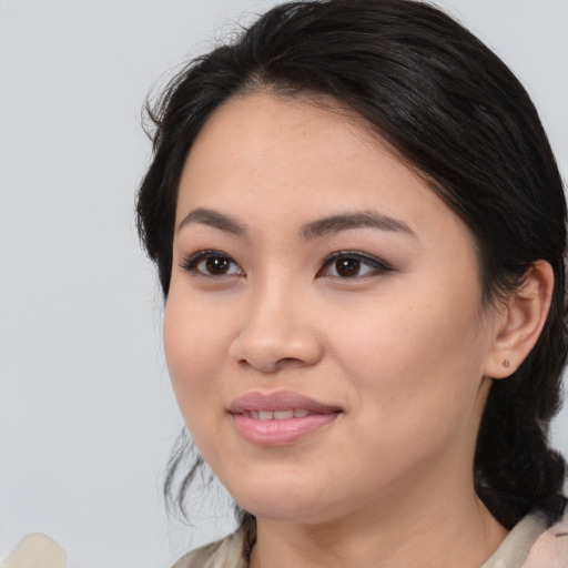 Joyful white young-adult female with medium  black hair and brown eyes