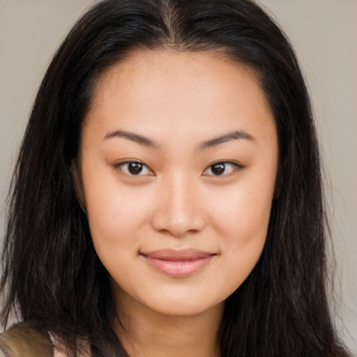 Joyful asian young-adult female with long  brown hair and brown eyes