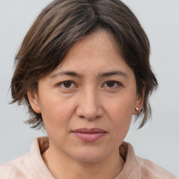 Joyful white adult female with medium  brown hair and brown eyes