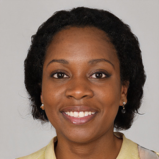 Joyful black young-adult female with medium  black hair and brown eyes
