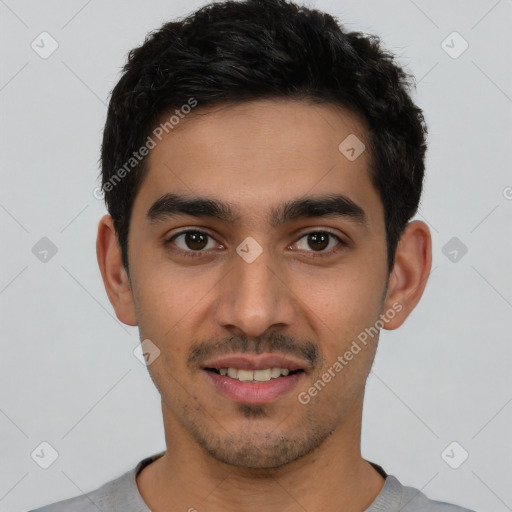 Joyful white young-adult male with short  black hair and brown eyes