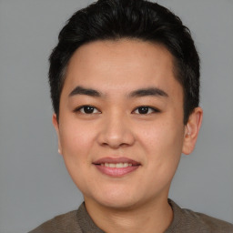 Joyful asian young-adult male with short  brown hair and brown eyes