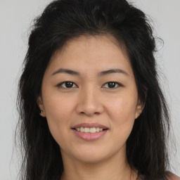 Joyful asian young-adult female with long  brown hair and brown eyes