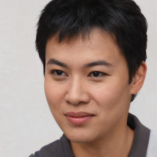Joyful asian young-adult male with short  brown hair and brown eyes