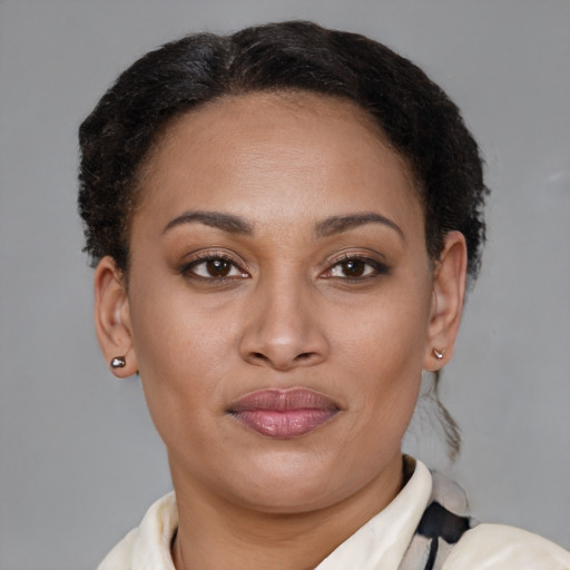 Joyful latino young-adult female with short  brown hair and brown eyes