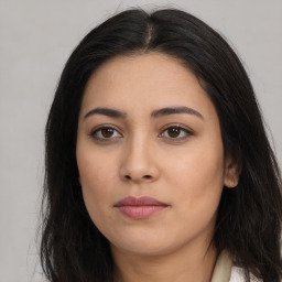 Joyful latino young-adult female with long  brown hair and brown eyes