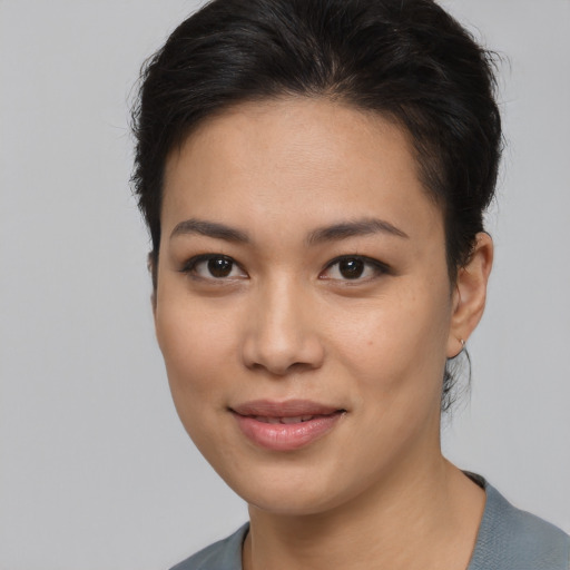 Joyful asian young-adult female with medium  brown hair and brown eyes