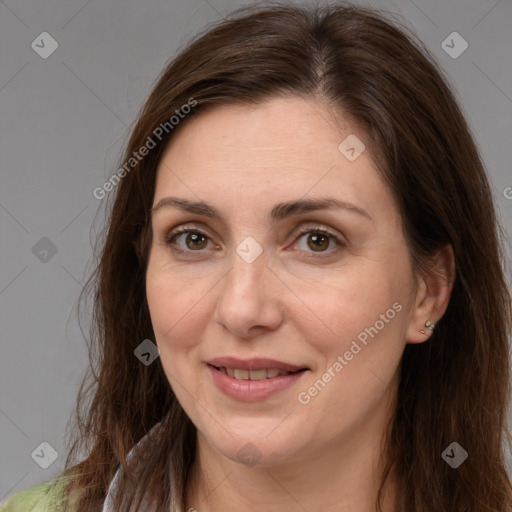 Joyful white adult female with long  brown hair and brown eyes