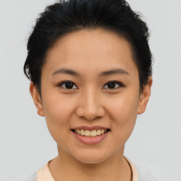 Joyful asian young-adult female with short  brown hair and brown eyes