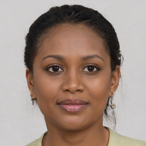 Joyful black young-adult female with short  brown hair and brown eyes