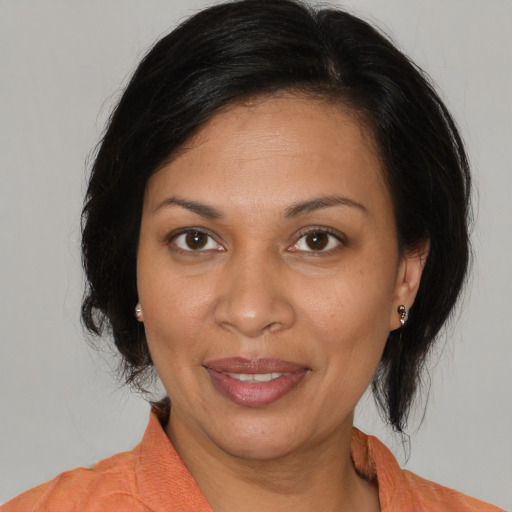 Joyful black adult female with medium  brown hair and brown eyes