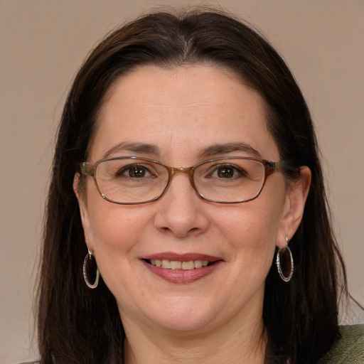 Joyful white adult female with long  brown hair and grey eyes