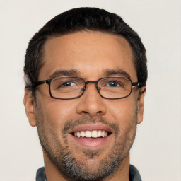 Joyful white young-adult male with short  black hair and brown eyes