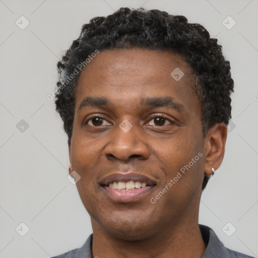 Joyful black young-adult male with short  black hair and brown eyes