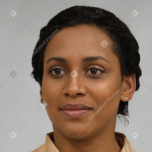 Joyful black young-adult female with short  black hair and brown eyes