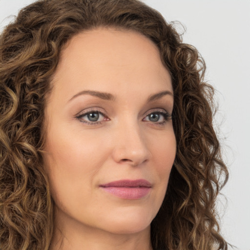 Joyful white young-adult female with long  brown hair and green eyes