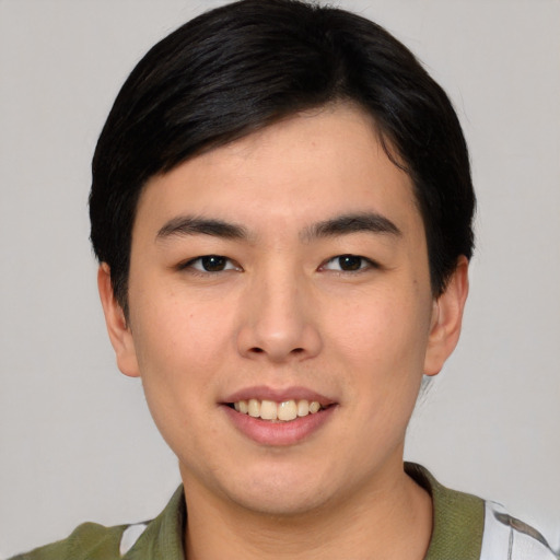 Joyful asian young-adult male with short  black hair and brown eyes