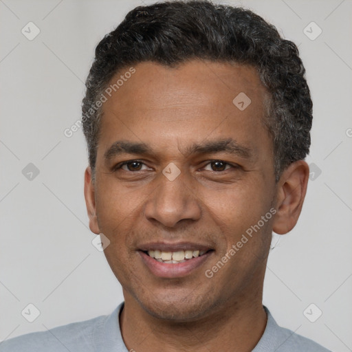 Joyful latino adult male with short  brown hair and brown eyes