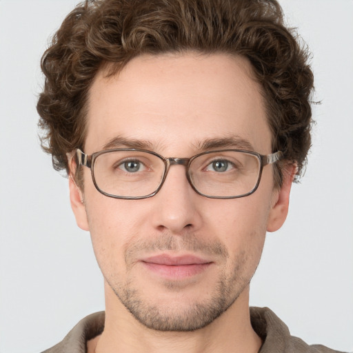 Joyful white adult male with short  brown hair and grey eyes