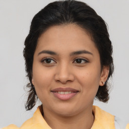 Joyful latino young-adult female with medium  brown hair and brown eyes