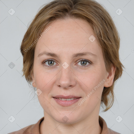 Joyful white adult female with medium  brown hair and grey eyes