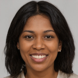 Joyful black young-adult female with medium  brown hair and brown eyes