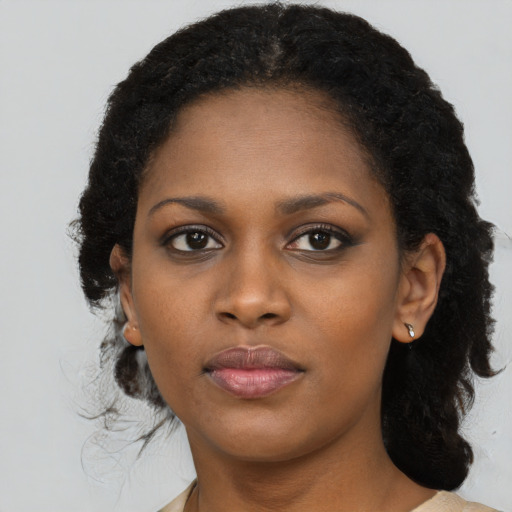 Joyful black young-adult female with medium  black hair and brown eyes