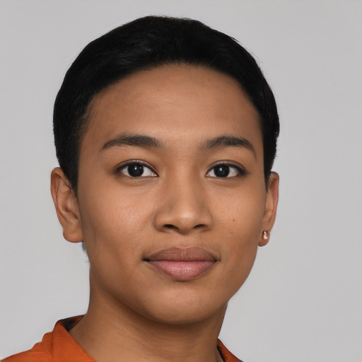 Joyful latino young-adult female with short  black hair and brown eyes