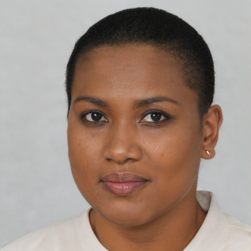Joyful black young-adult female with short  brown hair and brown eyes