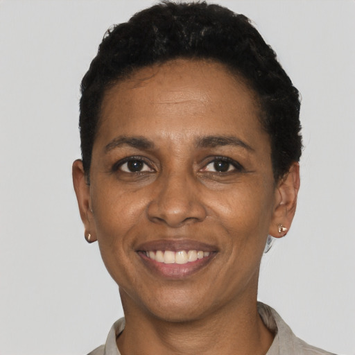 Joyful black young-adult female with short  black hair and brown eyes