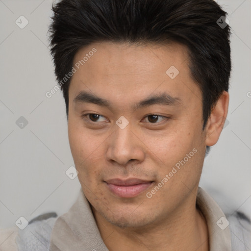 Joyful asian young-adult male with short  brown hair and brown eyes