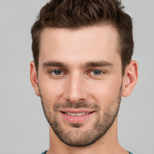 Joyful white young-adult male with short  brown hair and brown eyes