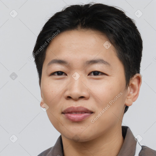 Joyful asian young-adult male with short  brown hair and brown eyes