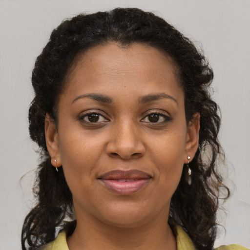 Joyful black young-adult female with medium  brown hair and brown eyes