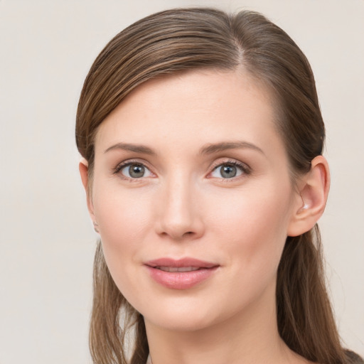 Joyful white young-adult female with long  brown hair and grey eyes